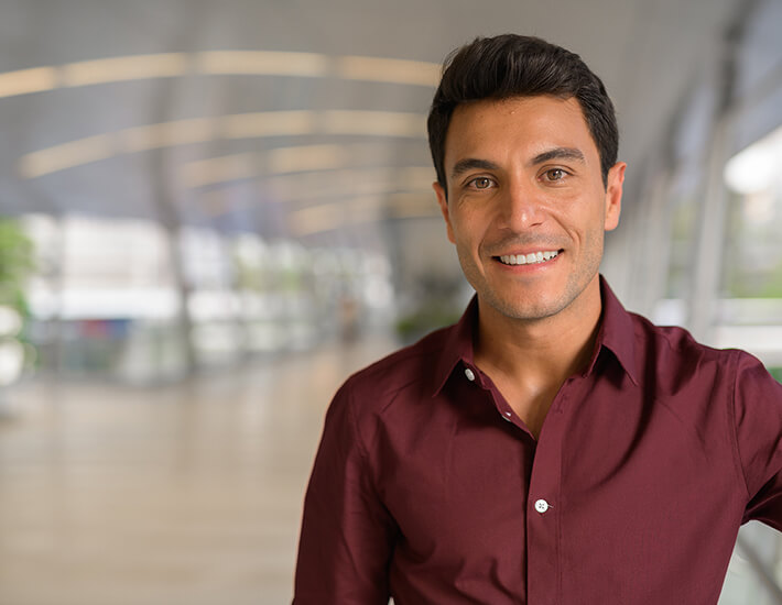 A man wearing formal attire looking at the camera.